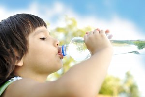child outside drinking water