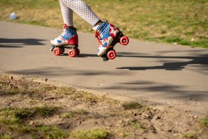 Ankle down photo of person wearing red white and blue roller skates
